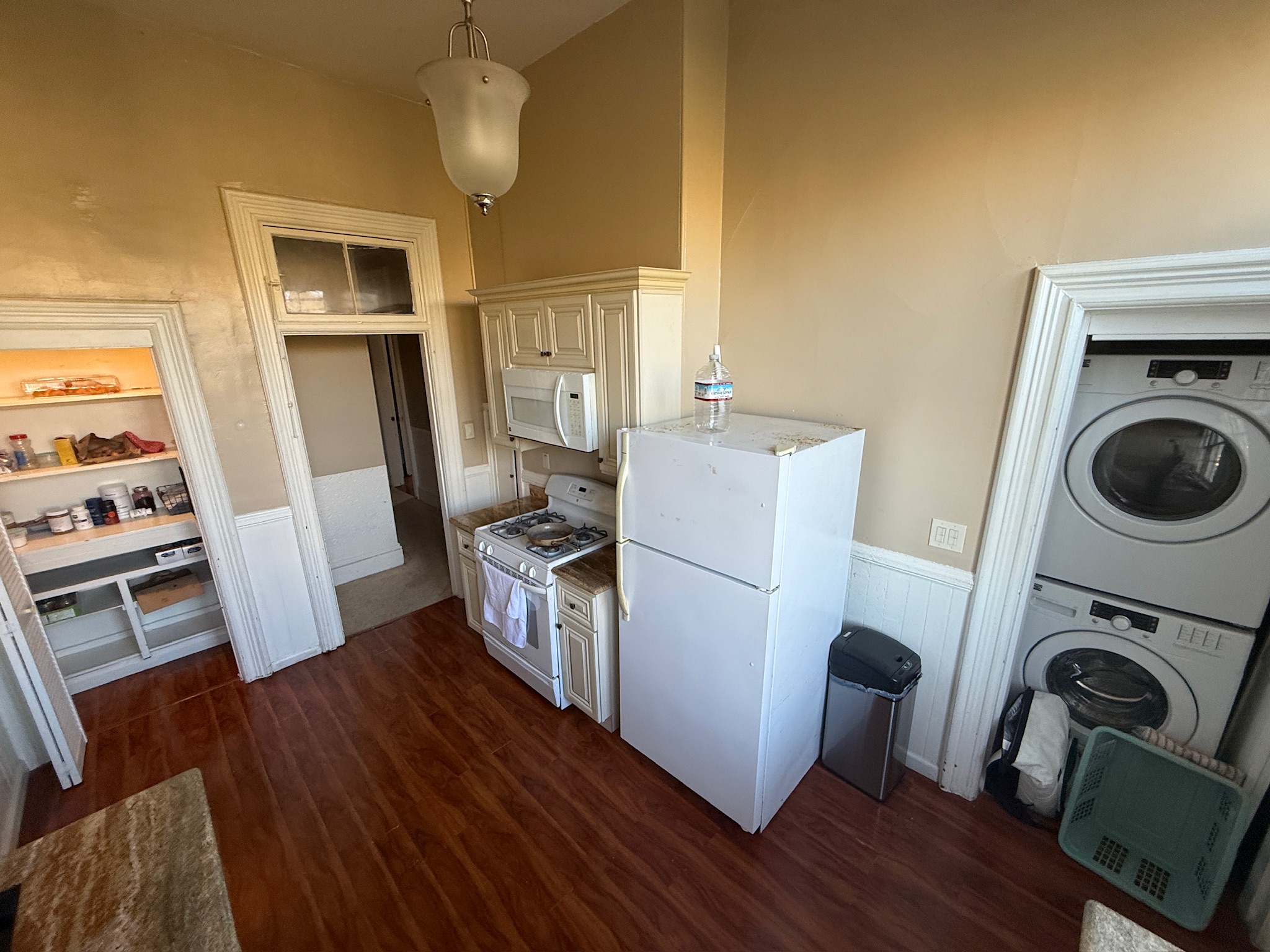 Full kitchen with stove, fridge, and laundry access