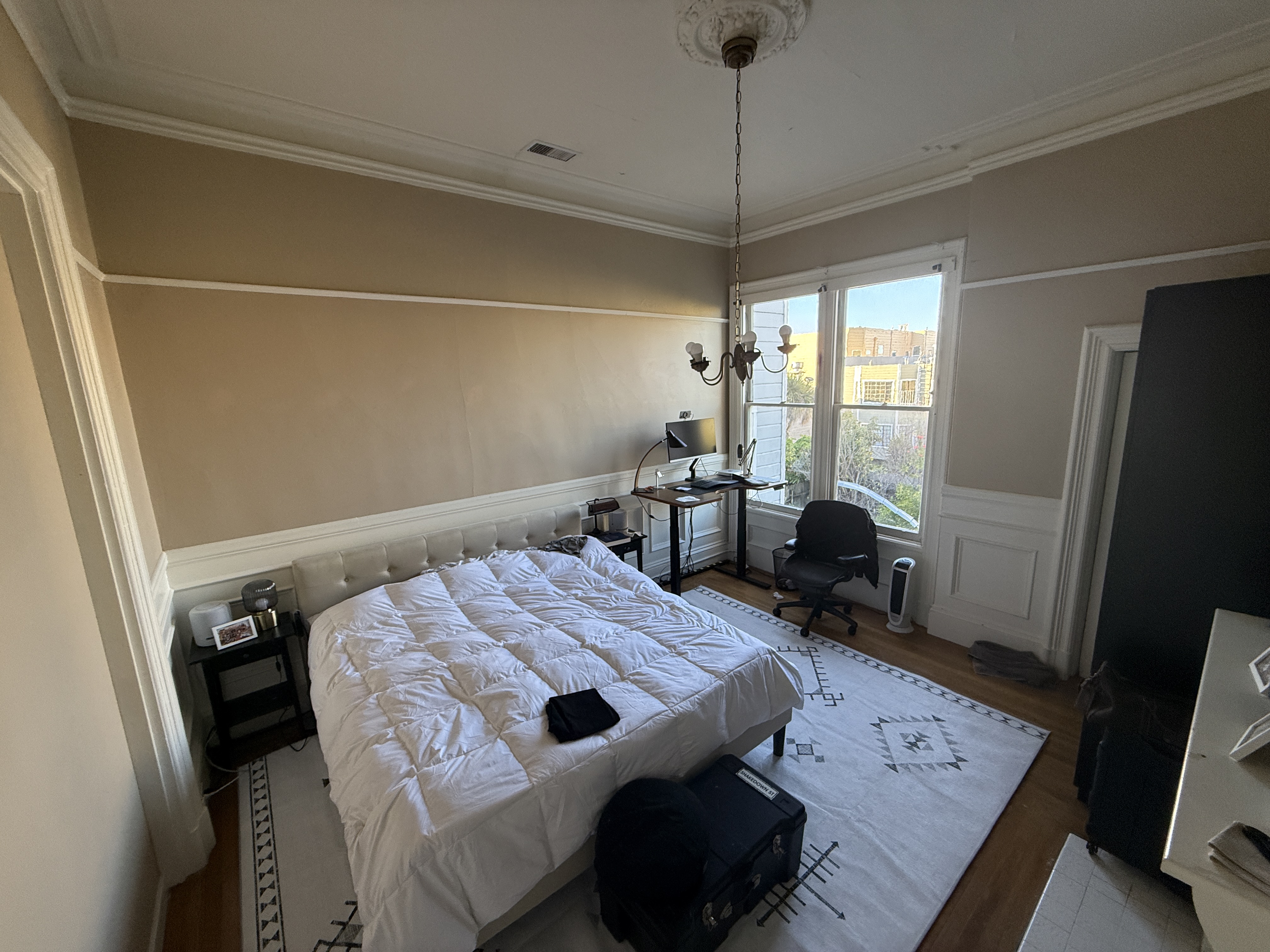 Painted Ladies Suite with city views and tufted headboard