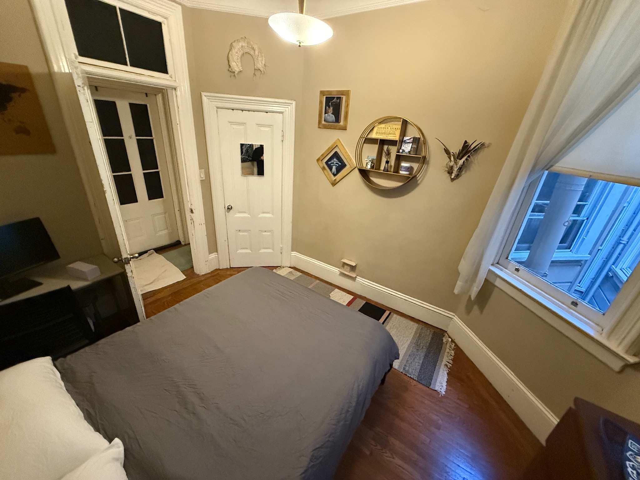 Skylight bedroom with dark bedding and gallery wall