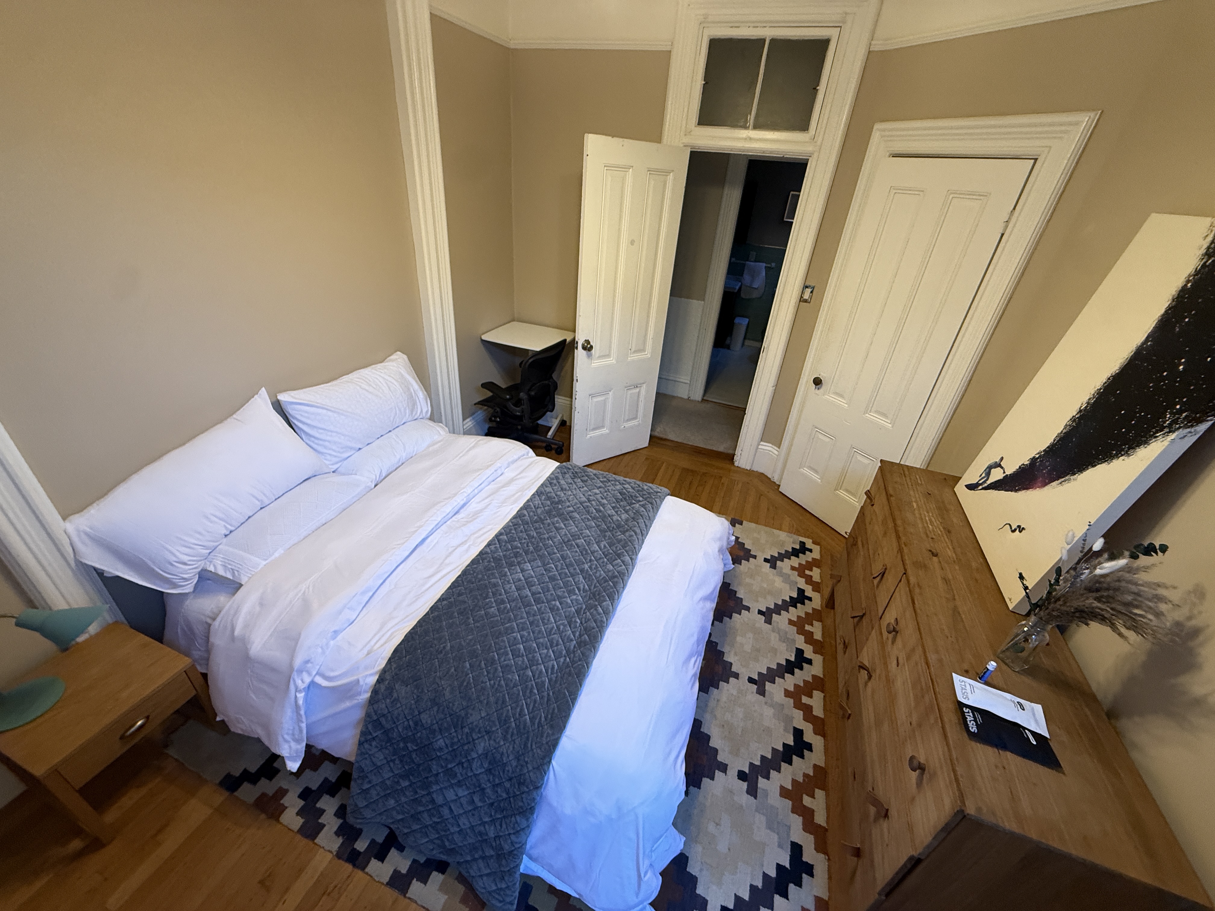 Bedroom with dresser and open closet doors