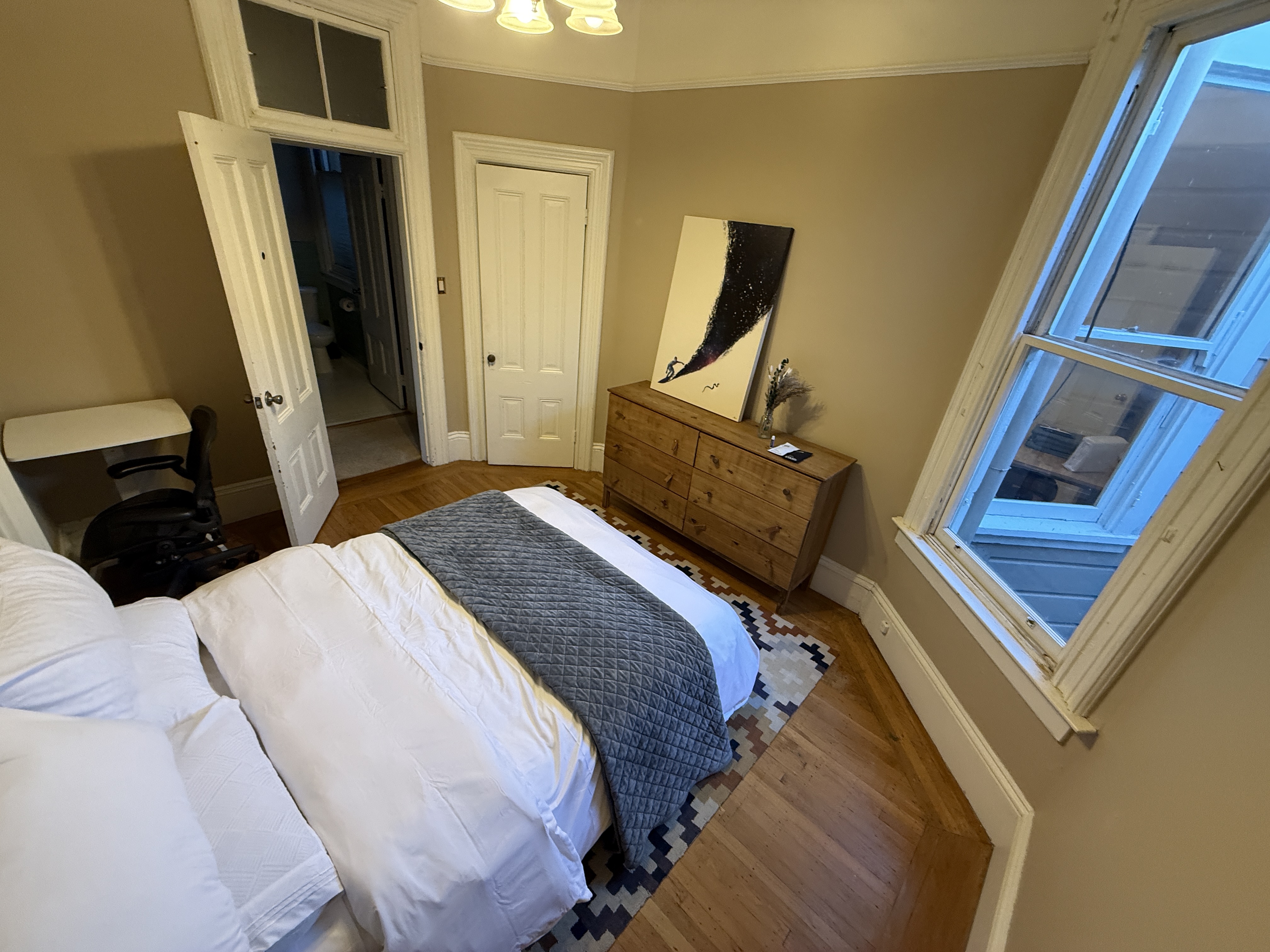 Bedroom with skylight and abstract art